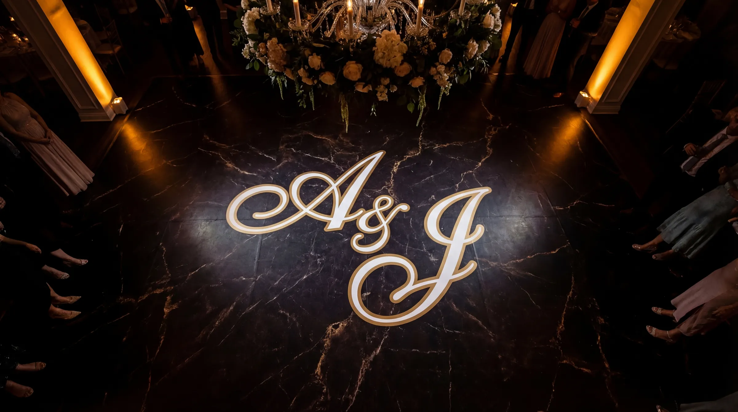 Elegant wedding dance floor wrap with custom monogram initials on dark marble surface